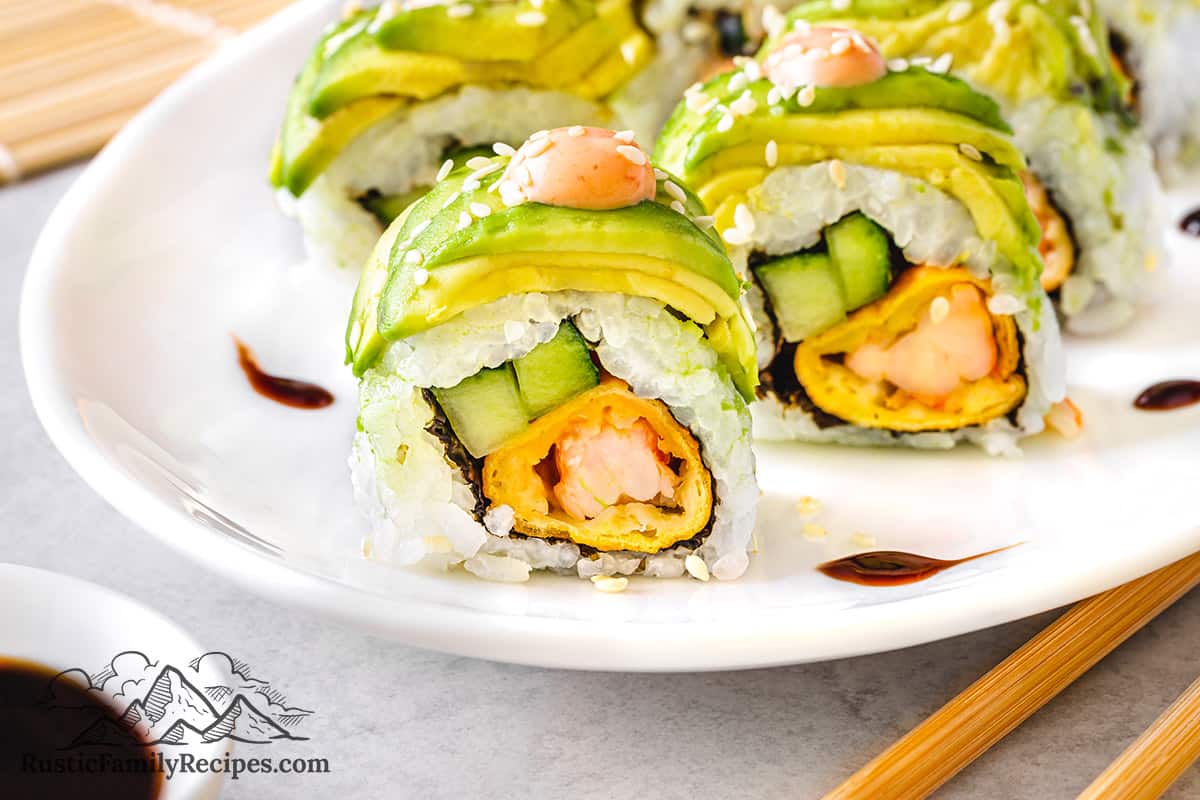 Dragon roll with spicy mayo and sesame seeds.