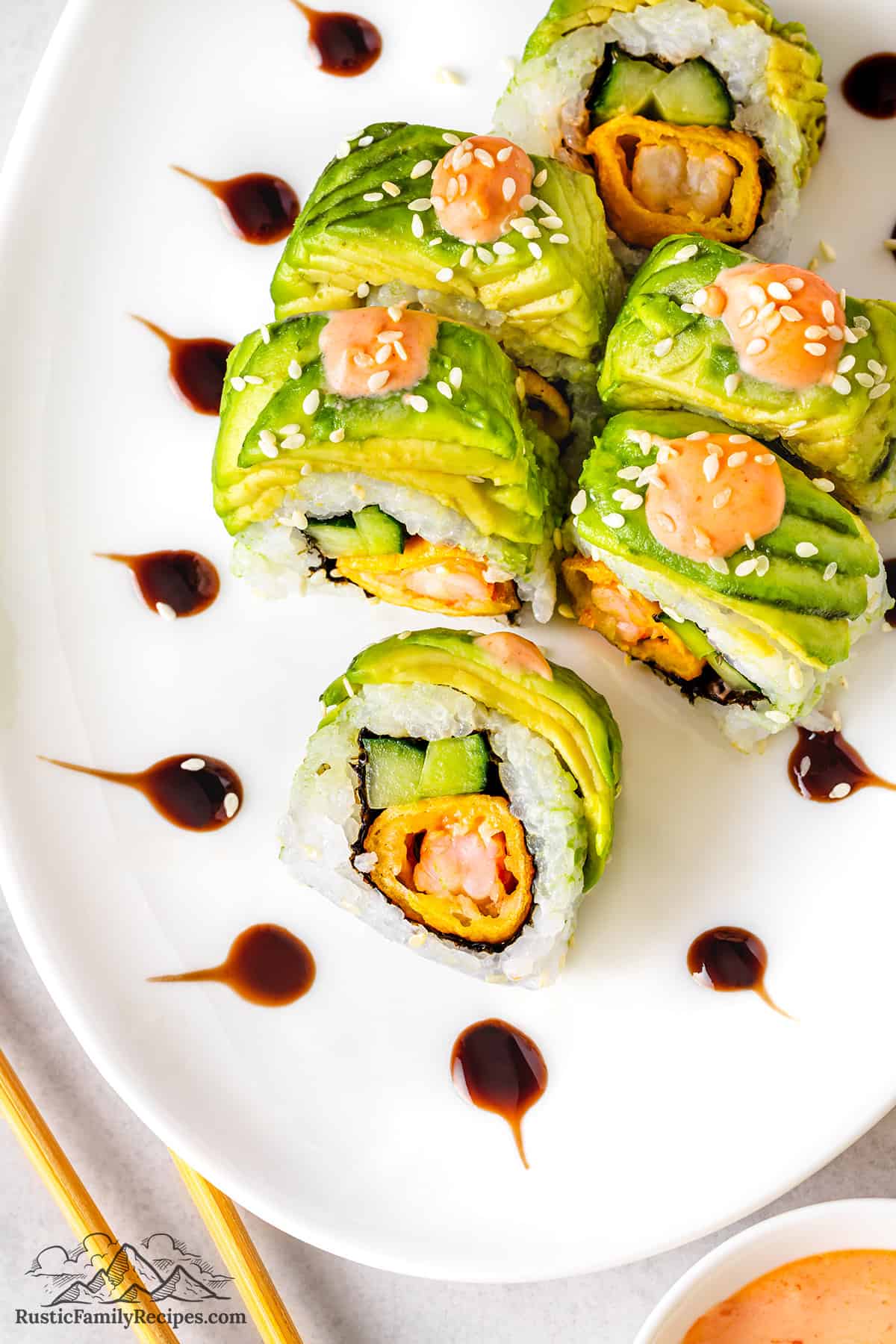 Dragon roll with sesame seeds and spicy mayo on top. 