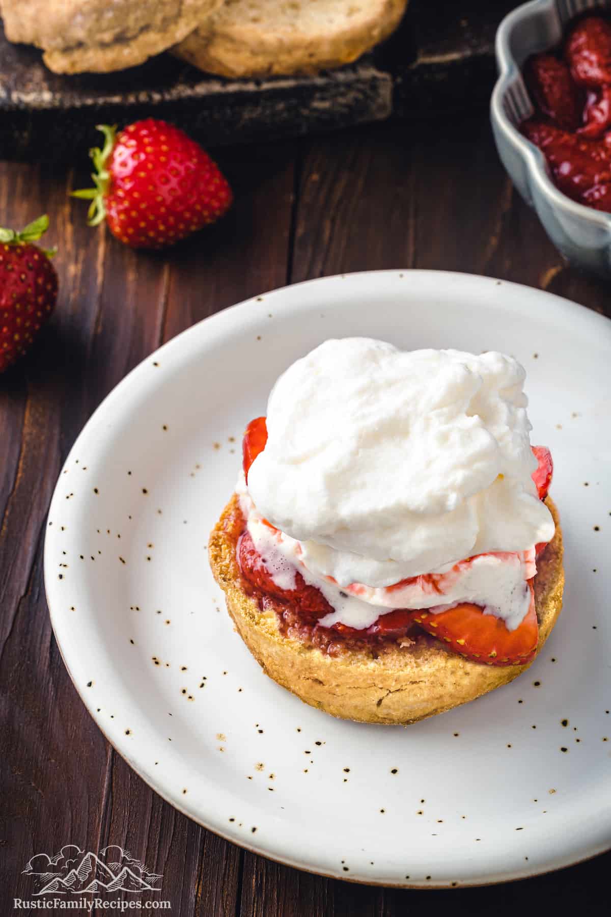 Whipped cream, strawberries and half a shortcake on a plate