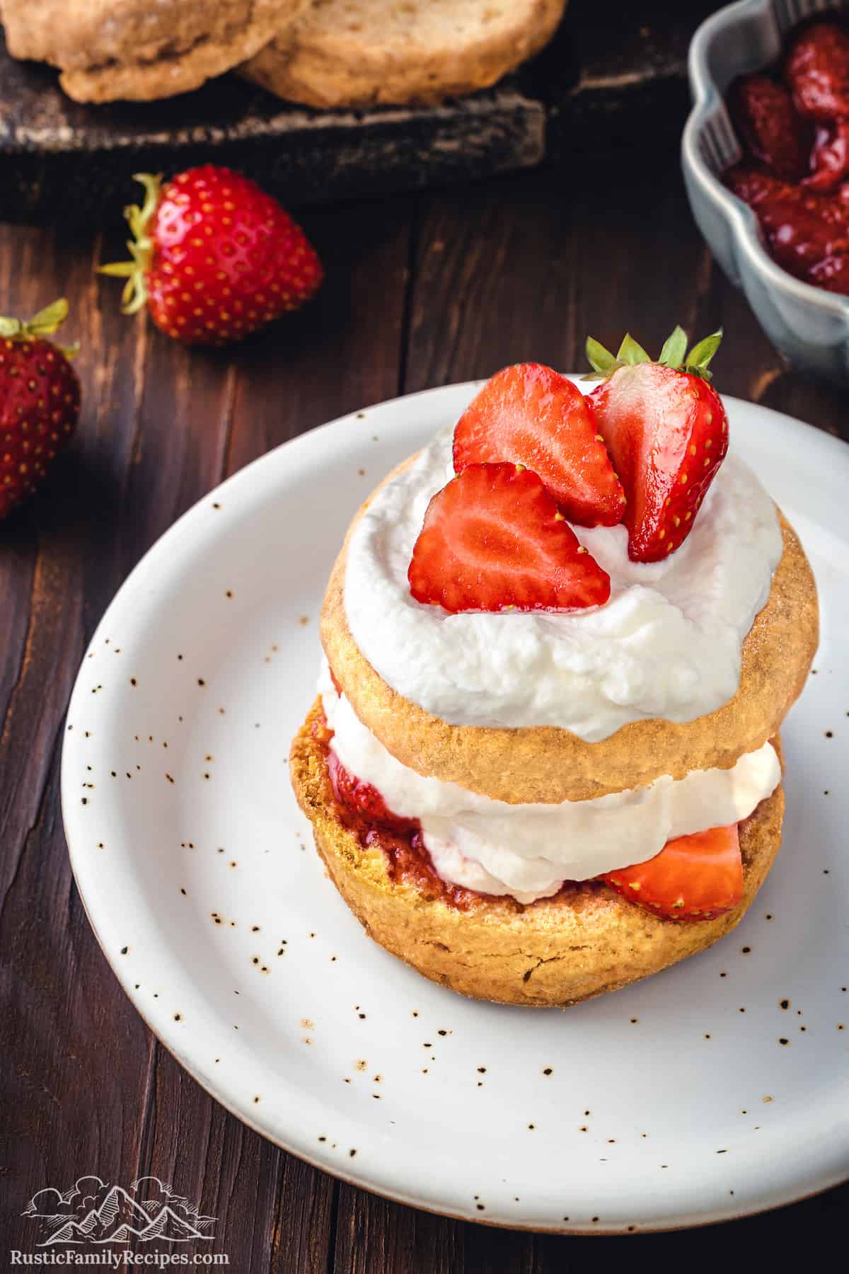 Strawberries, whipped cream, strawberries and a shortcake on a plate