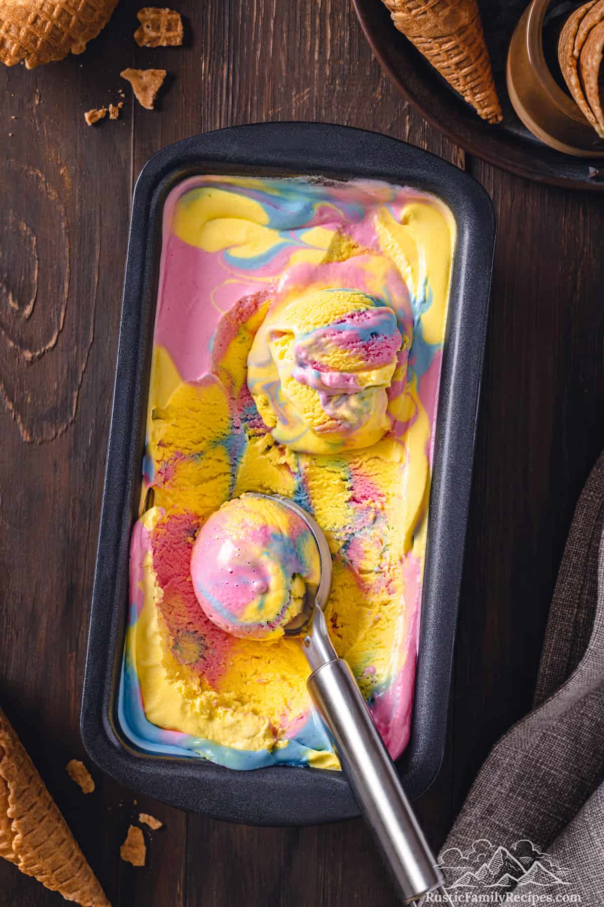 Top view of homemade Superman ice cream being scooped from a loaf pan.