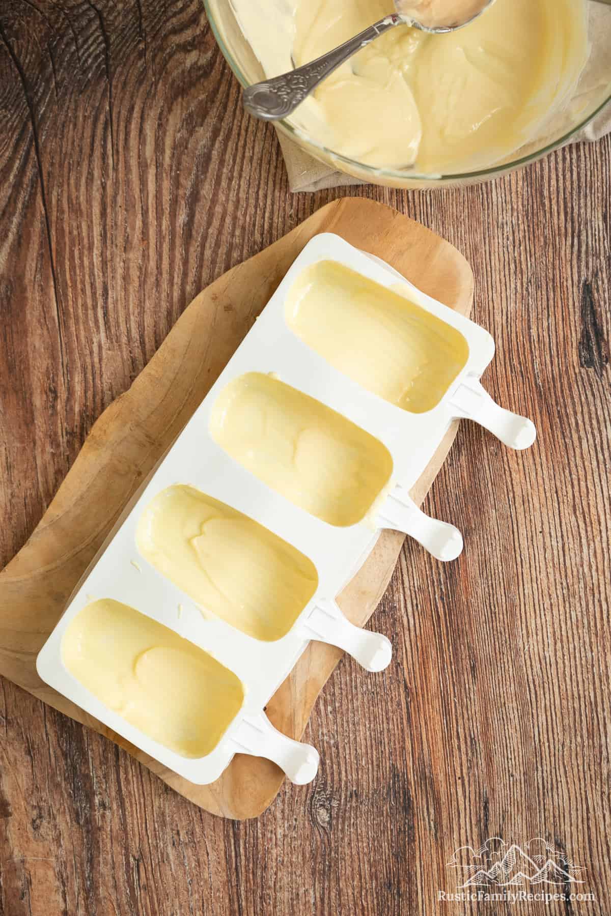 Cakesicle molds lined with white chocolate.