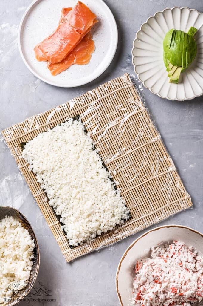 Nori on a sushi mat with rice
