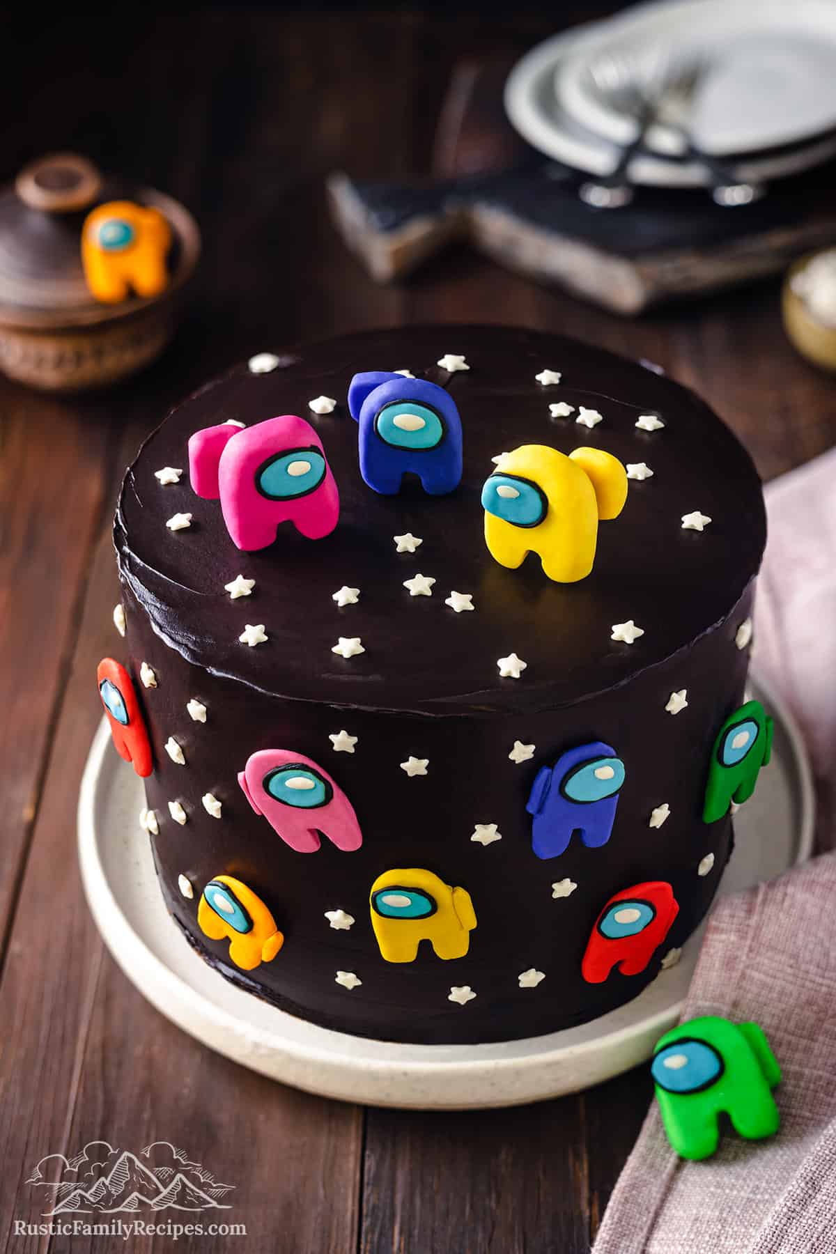 Decorated Among Us cake with black frosting and fondant characters