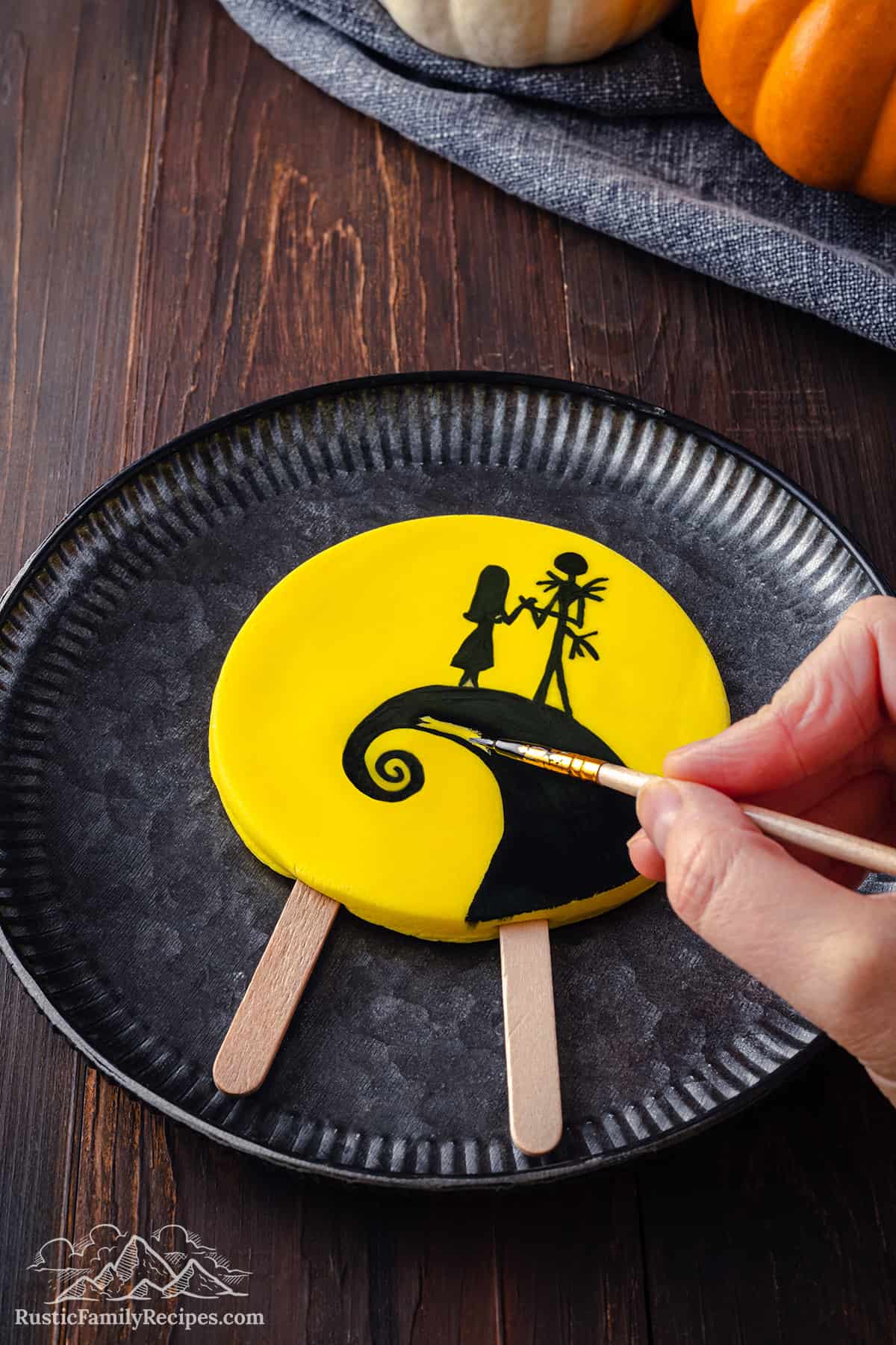 A Spiral Hill yellow cake topper with Skellington Jack and Sally.