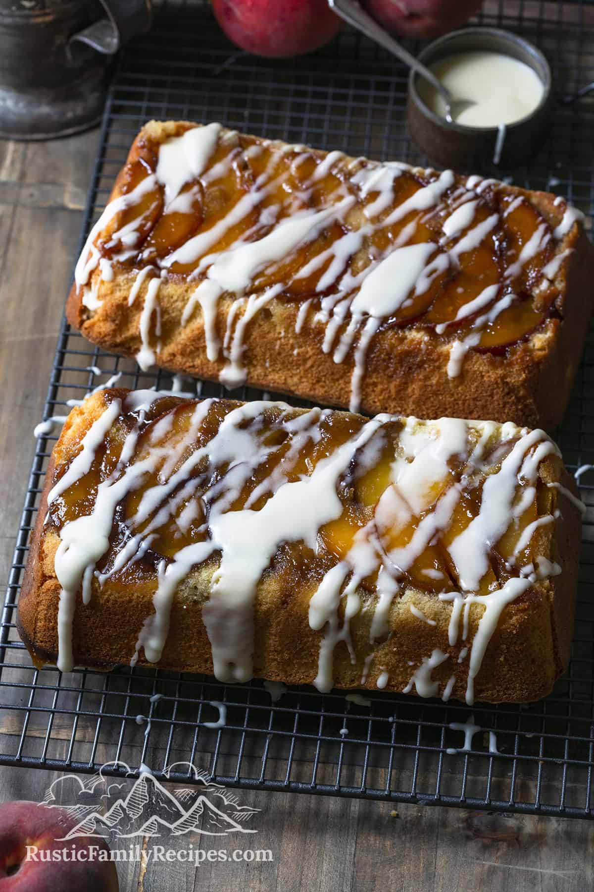 Two peach cobbler pound cakes on wire racks cooling