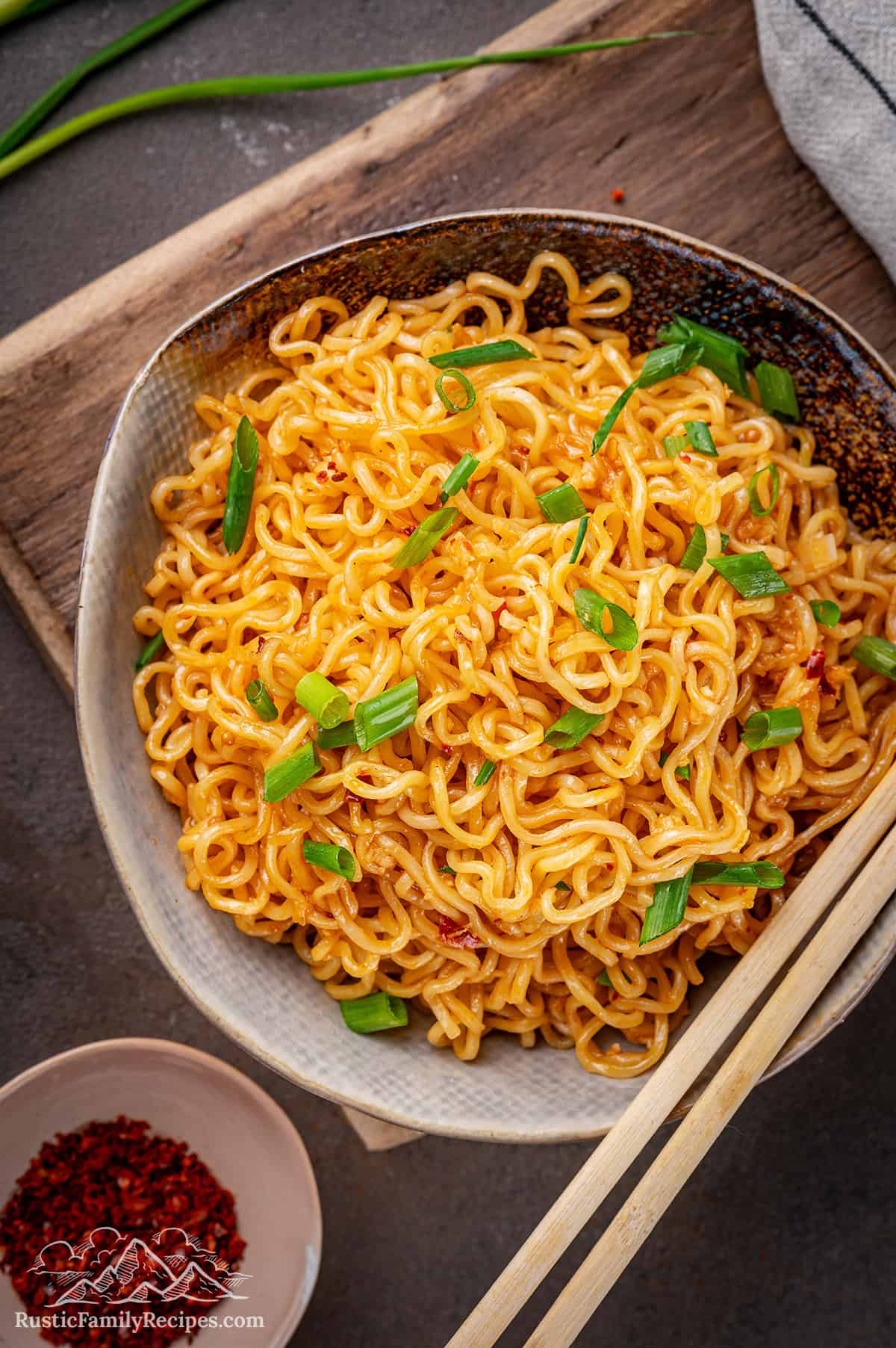 A bowl of spicy ramen noodles with chopsticks