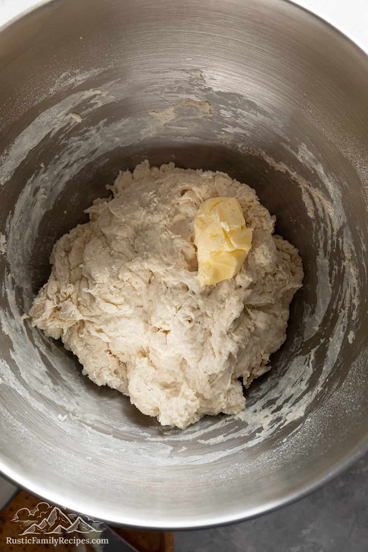 Adding the butter to the telera dough. 