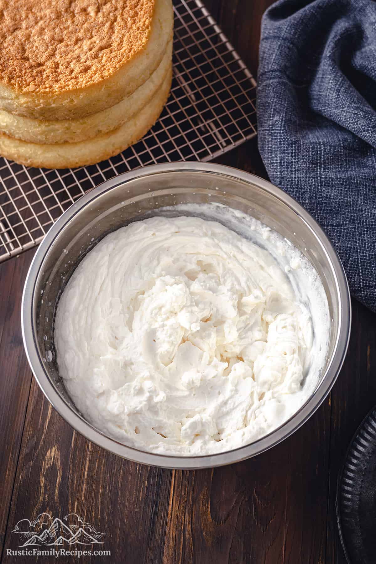 Whipped mascarpone cream in a stainless steel bowl. 