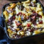 A baking dish with baked rigatoni and veggies
