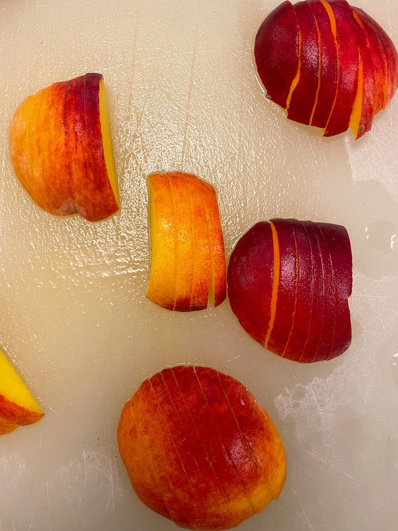 Sliced peaches on a cutting board