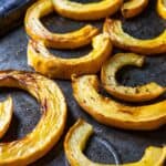 A baking sheet with roasted delicata squash