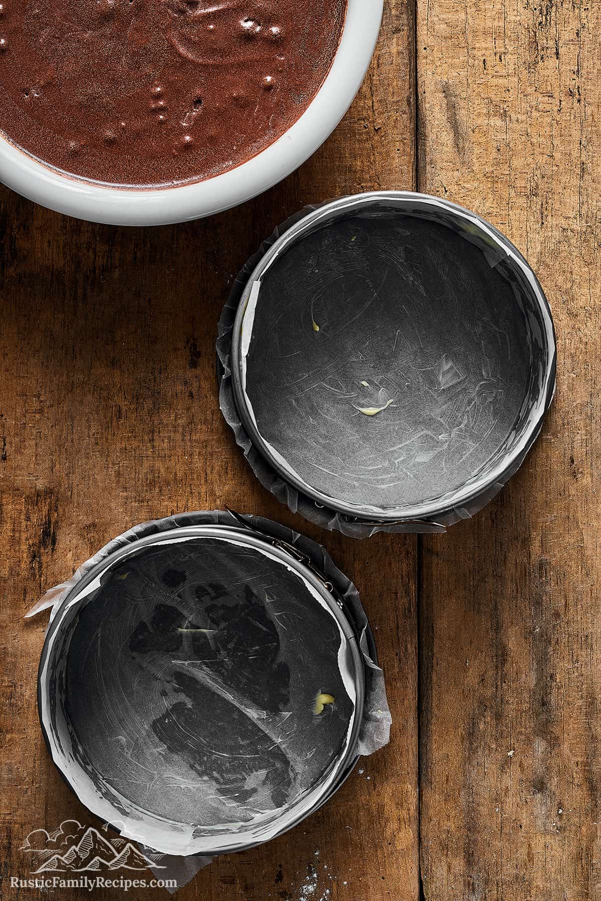 Lined cake pans prior to filling them with batter.