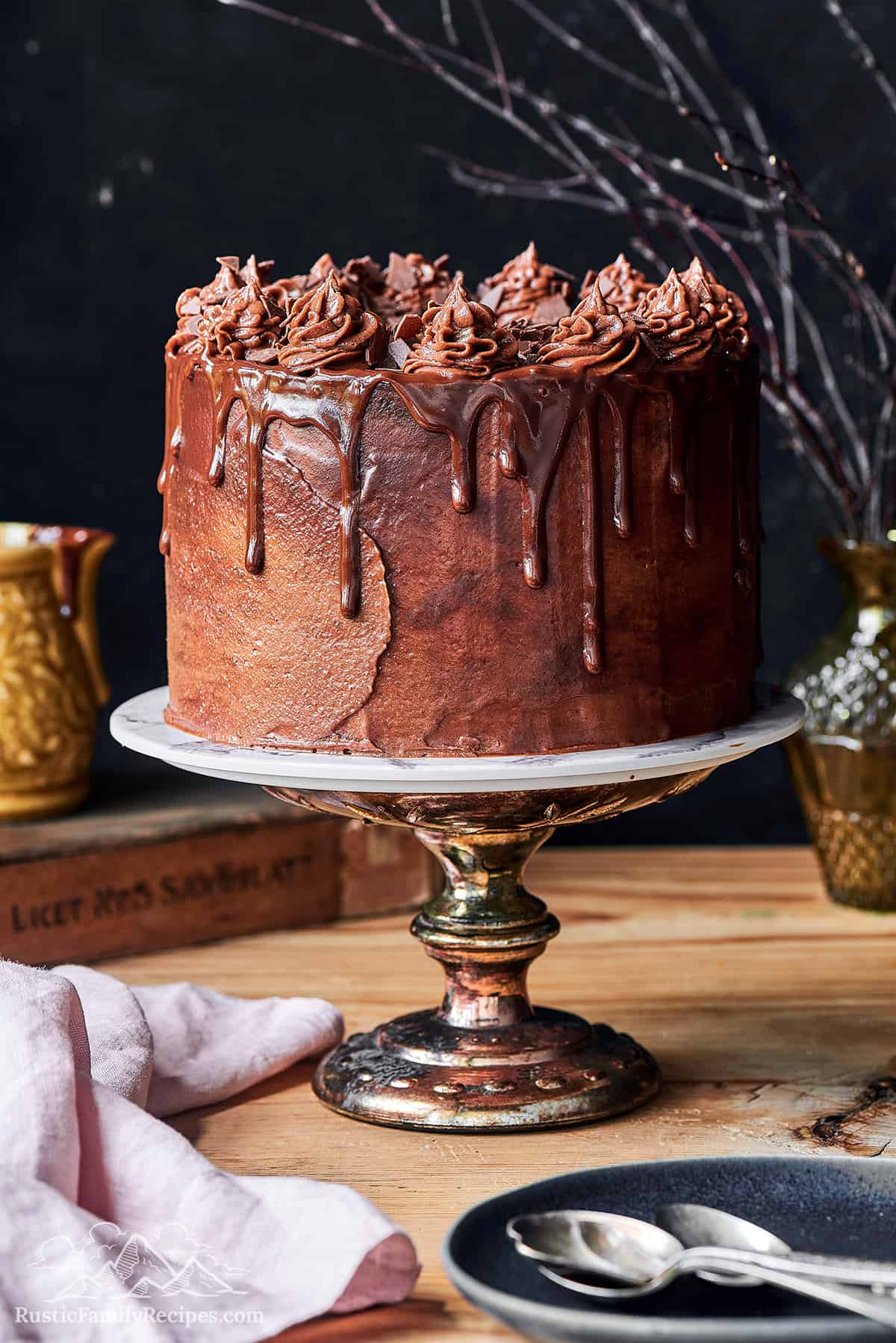 Whole devil's food cake on a cake stand.
