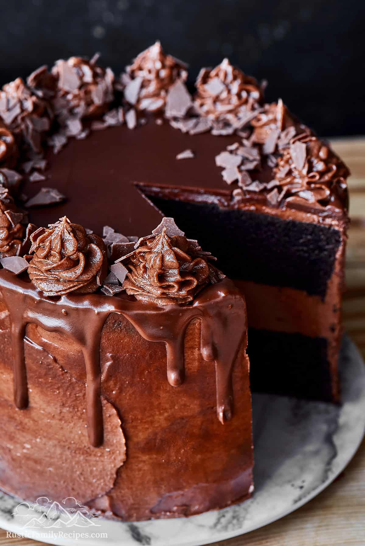 Close-up of sliced devil's chocolate cake drizzled with ganache.