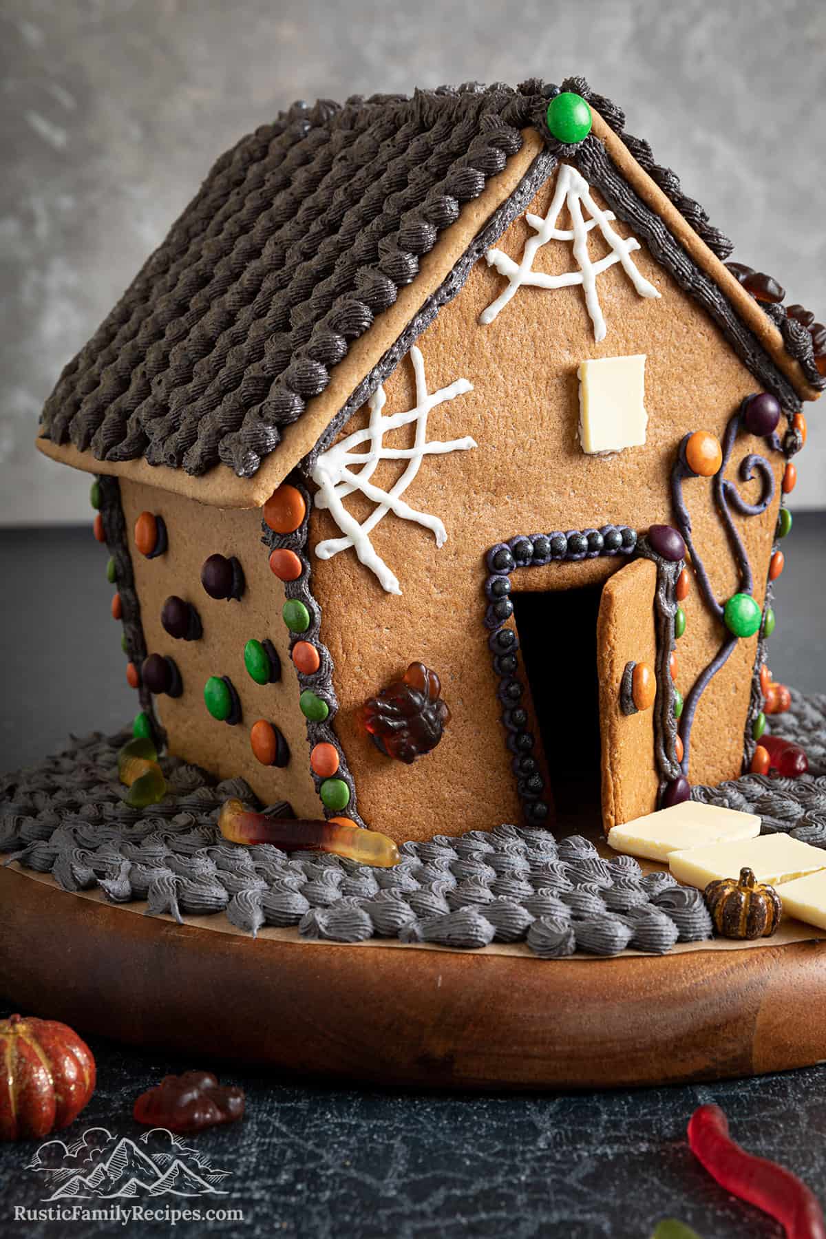 Decorated Halloween gingerbread house with an open door.