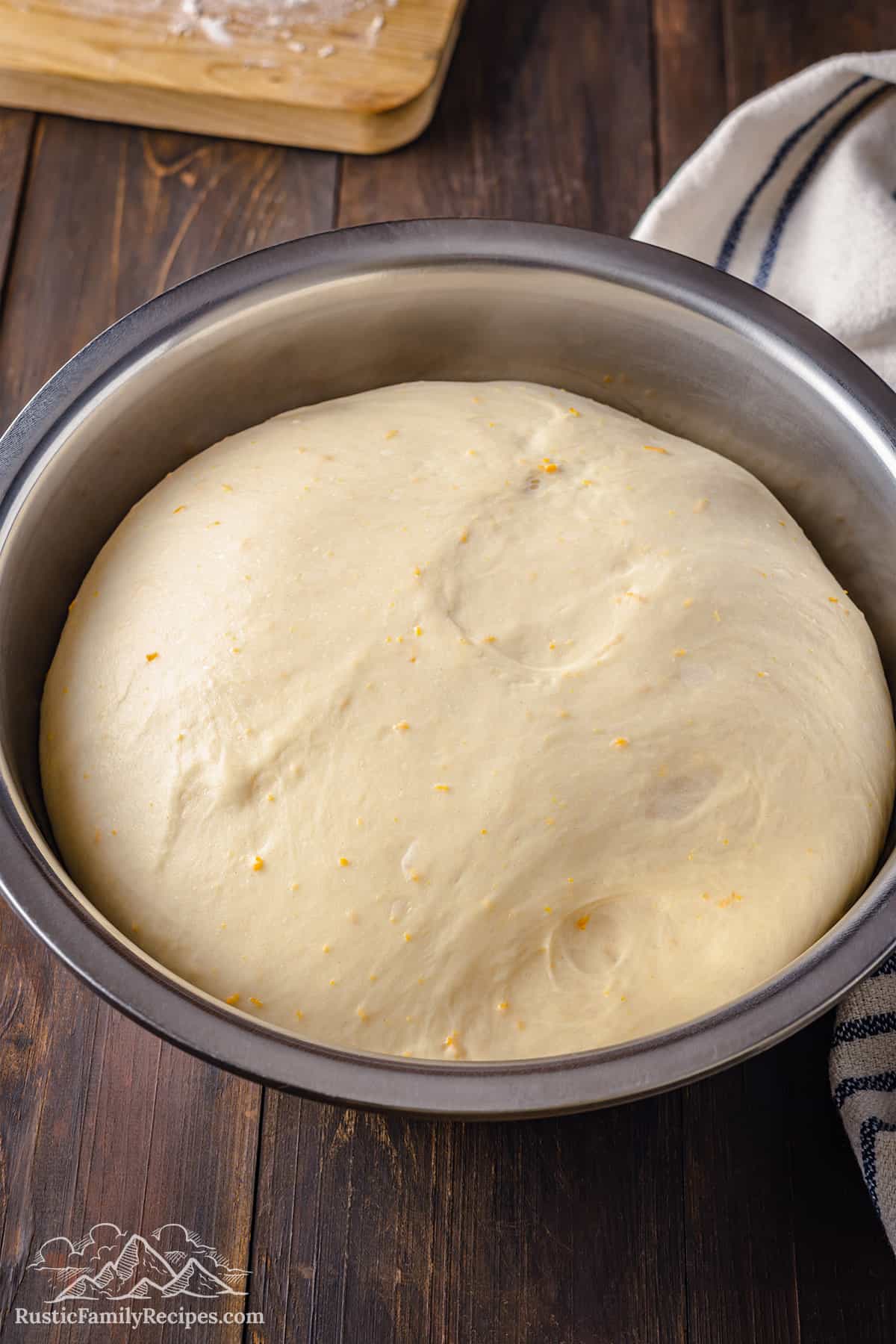 Risen pan de muerto dough in a bowl.
