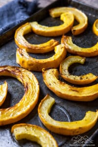 A baking sheet with roasted delicata squash