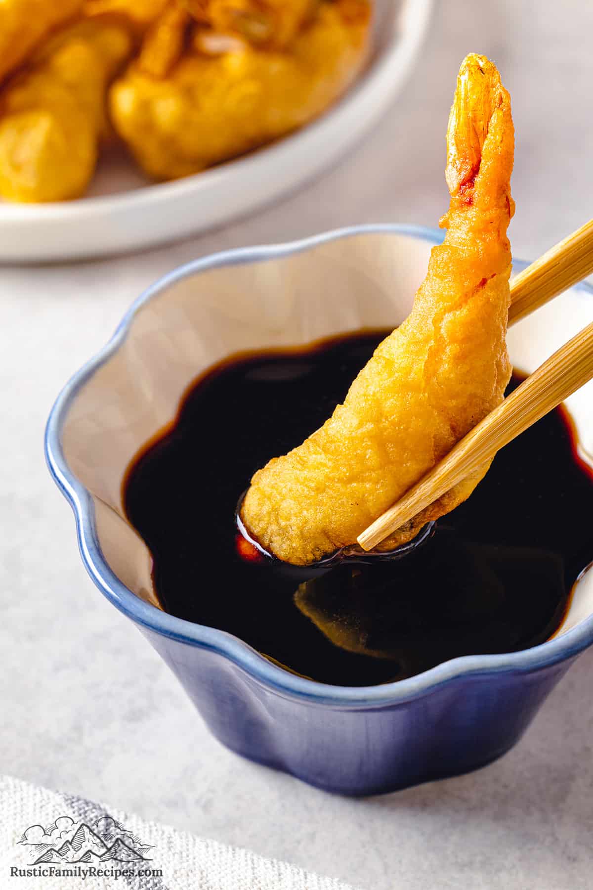 Dipping shrimp tempura in sauce