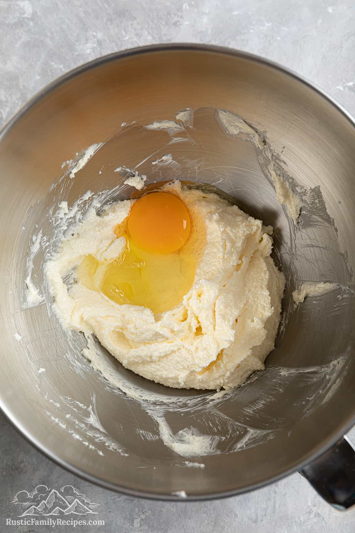Creamed butter with an egg in the bowl.