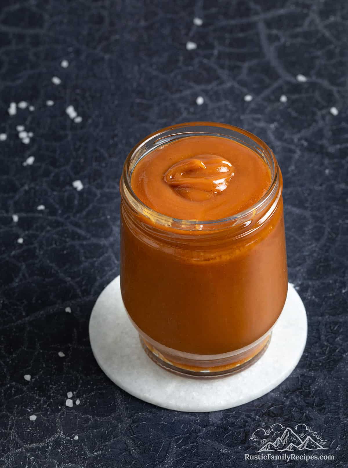 Salted caramel sauce in a glass jar.