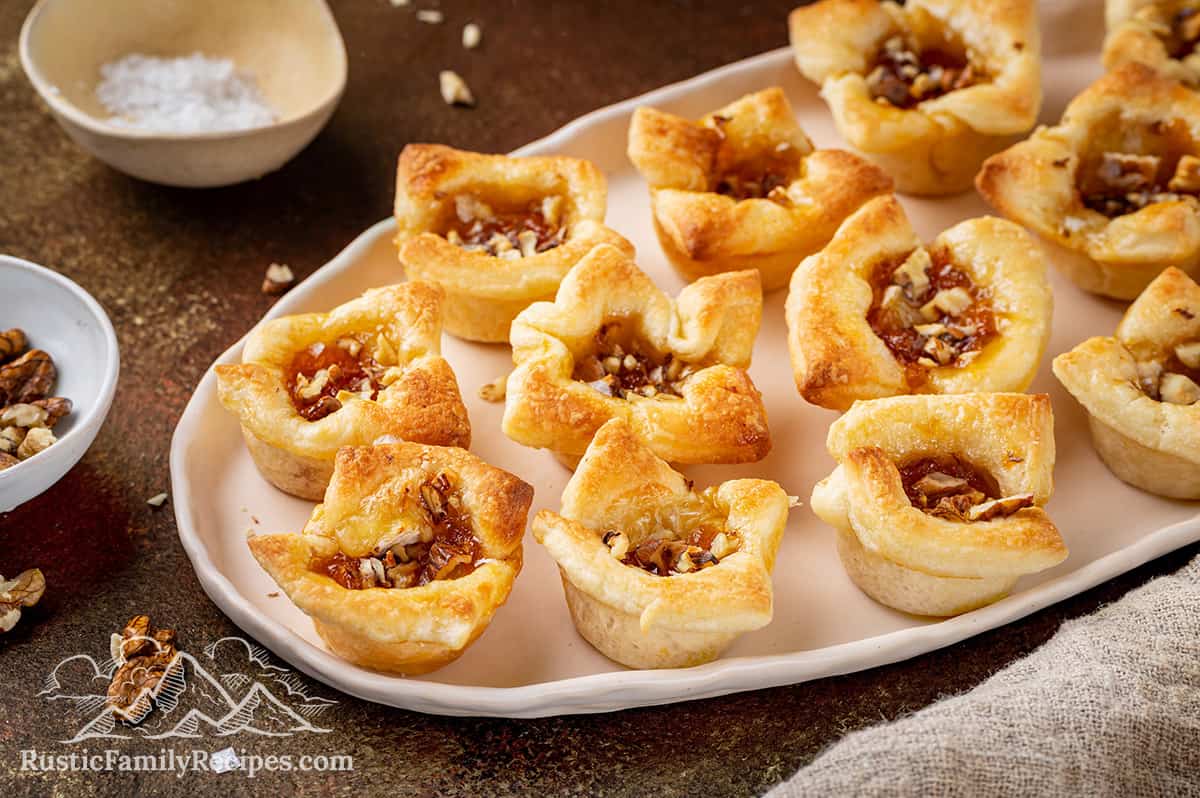 Apricot Brie Bites A tray of apricot brie bites next to salt and walnuts