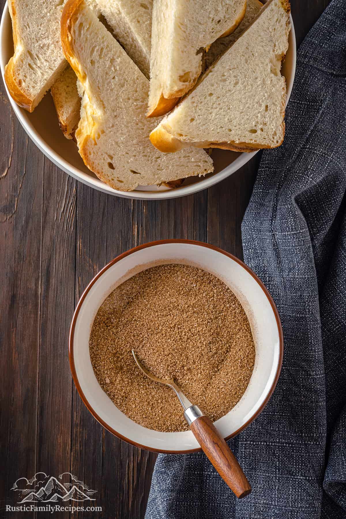 Cinnamon sugar in a bowl next to slices of challah