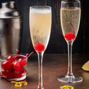 Two champagne glasses with french 76 cocktails