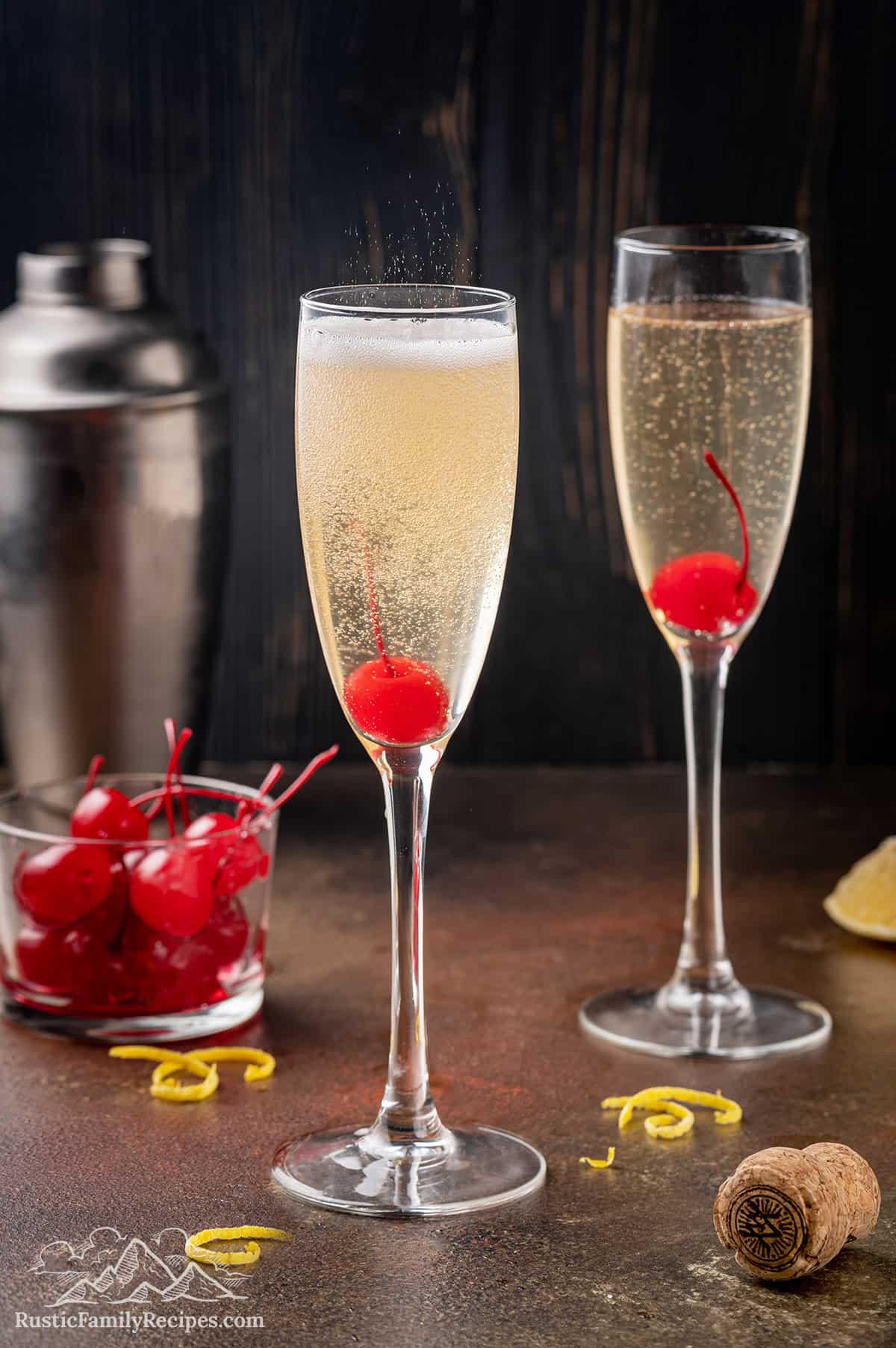 Two French 76 cocktails in champagne glasses