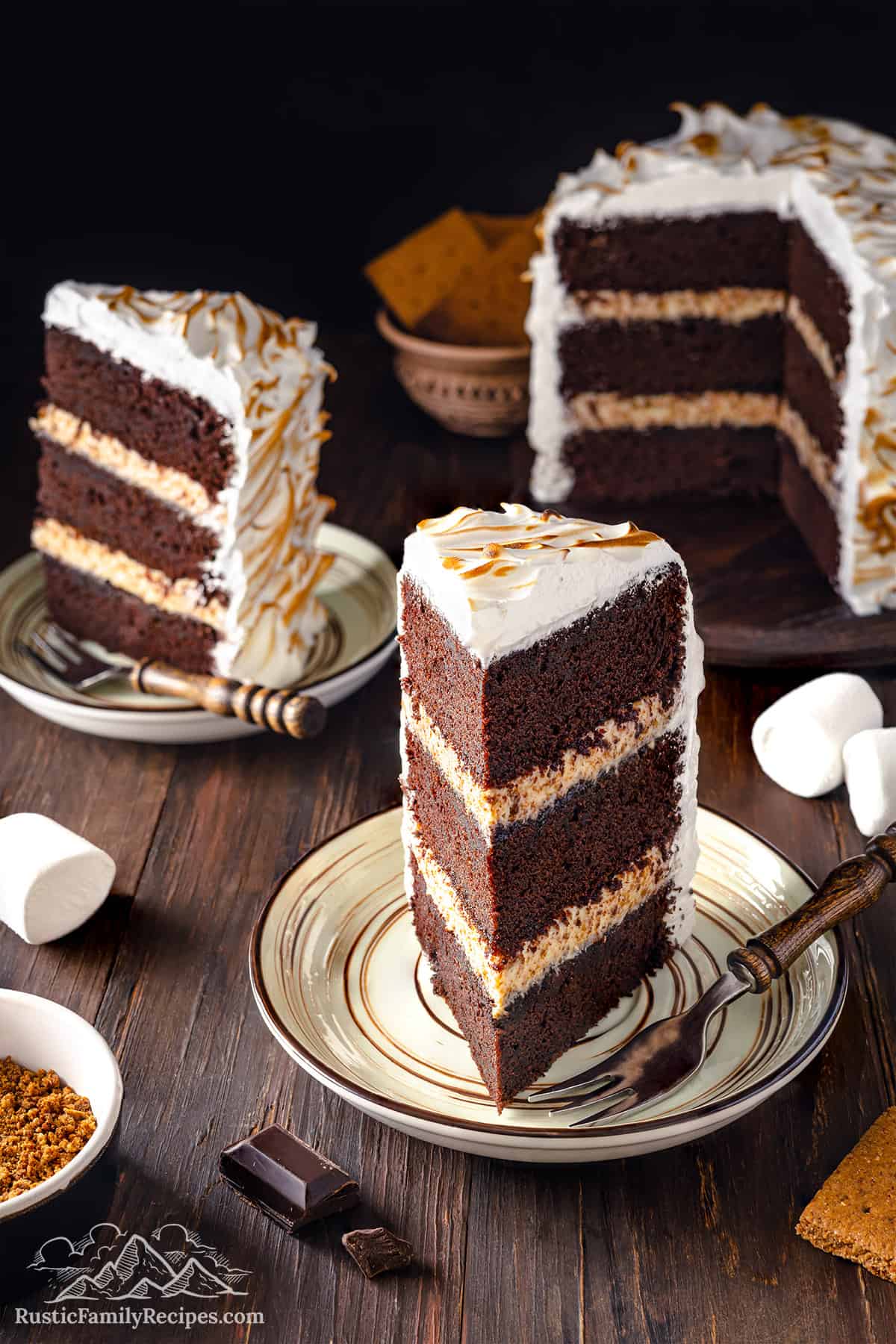 A slice of s'mores cake on a plate.