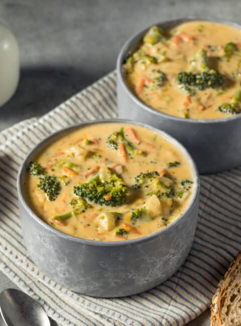 Two bowls of broccoli cheese soup
