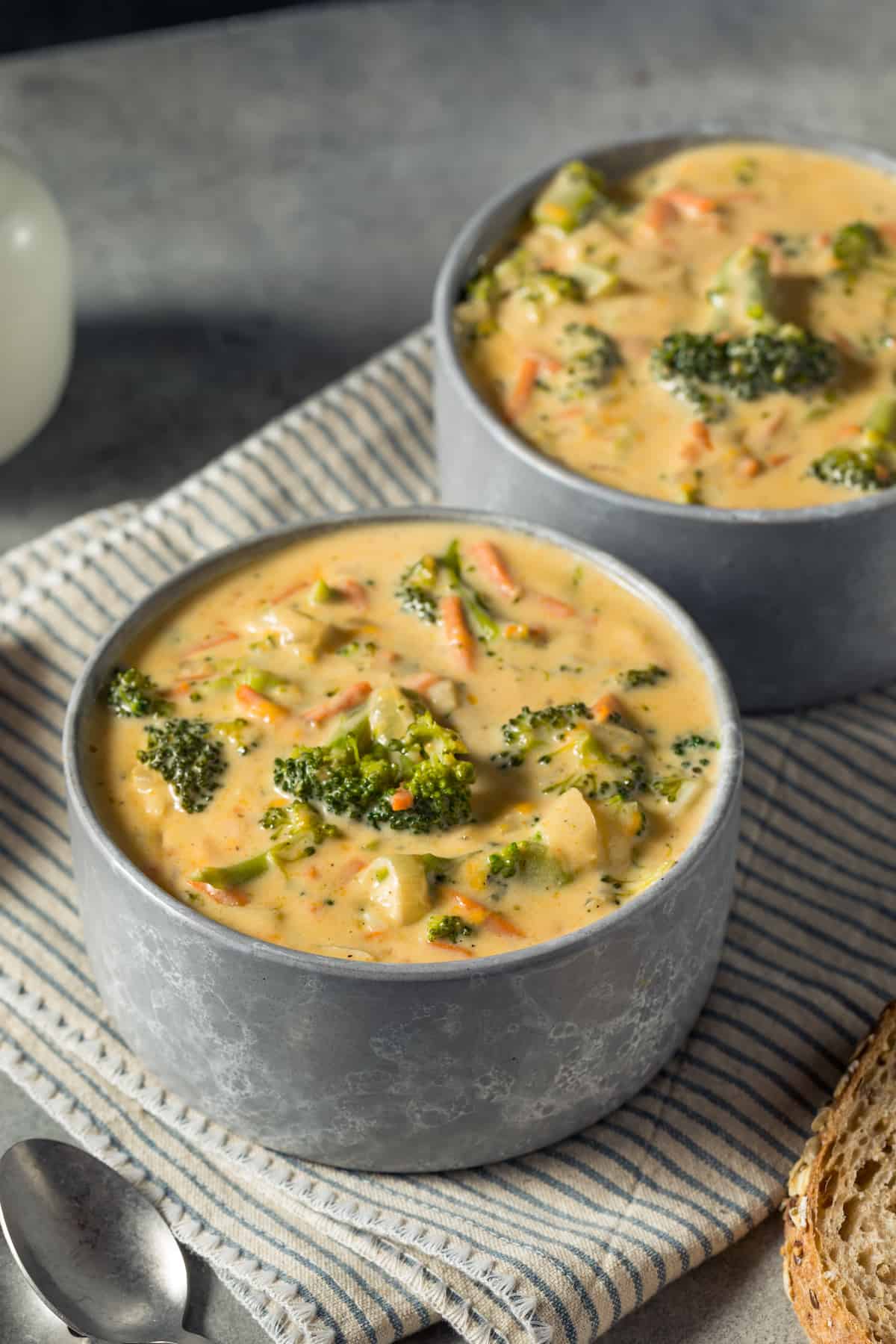 Two bowls of broccoli cheese soup