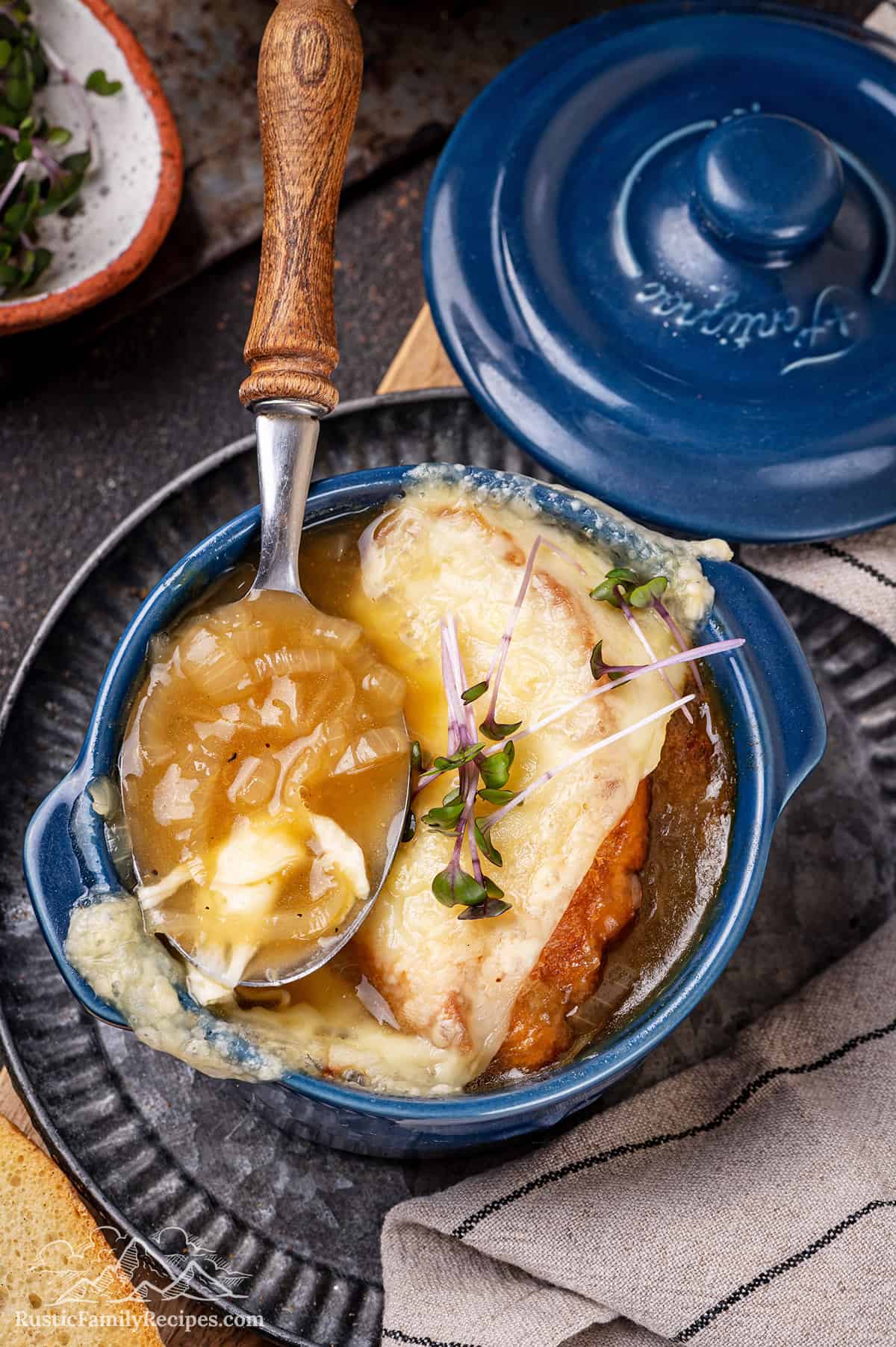 French onion soup in a ramekin with a spoon
