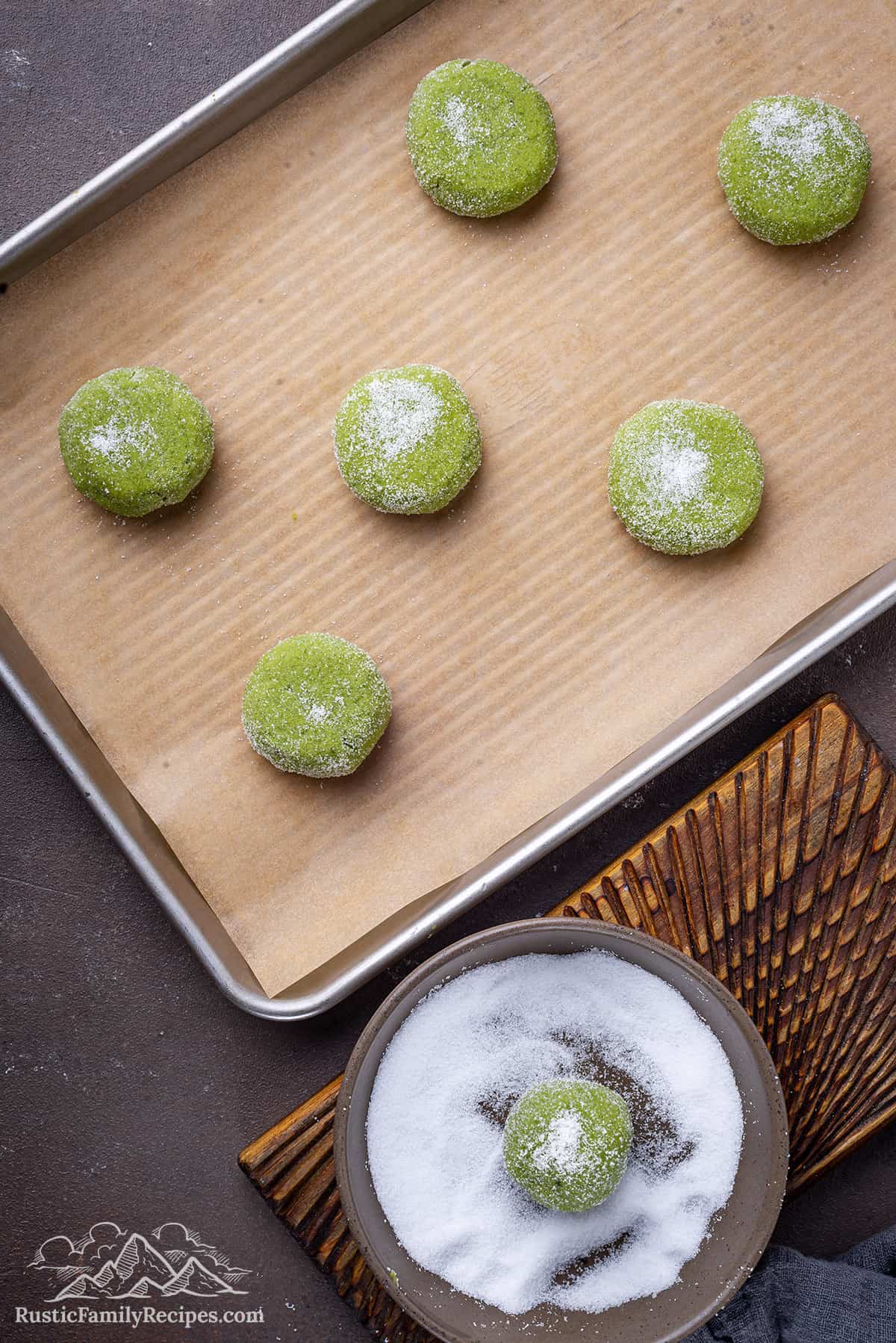 Balls of green cookie dough ready to bake