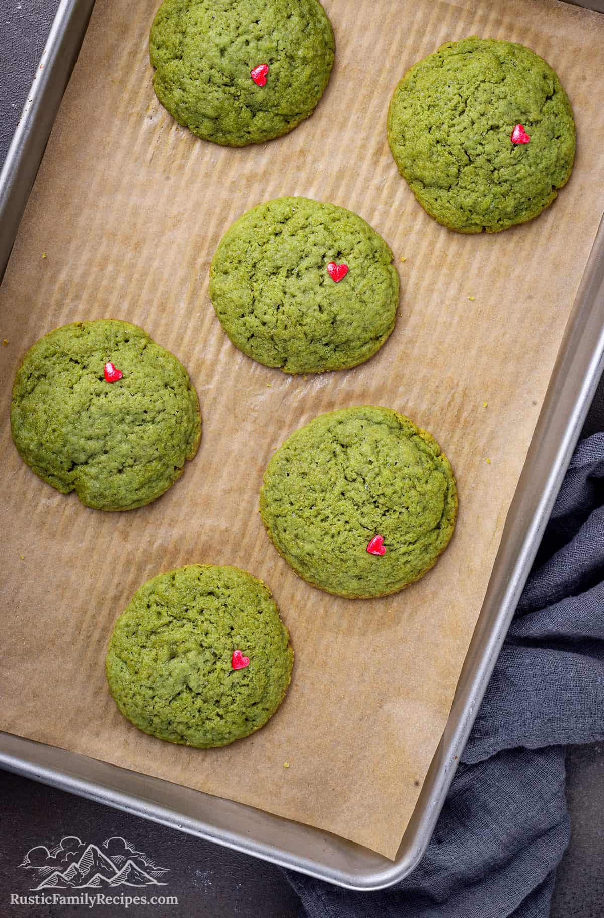 Grinch cookies on a baking sheet