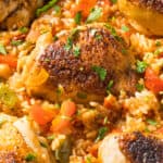 Close up of chicken thighs and legs as part of arroz con pollo