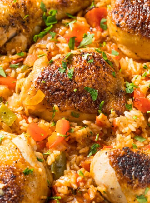 Close up of chicken thighs and legs as part of arroz con pollo