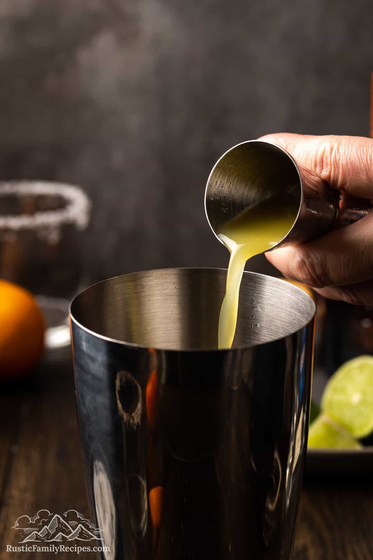Pouring orange juice into a cocktail shaker
