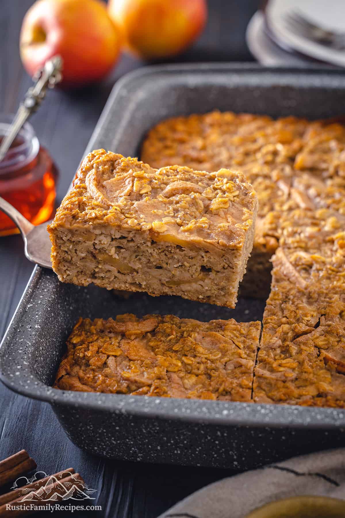 A slice of baked apple oatmeal being lifted on a spatula
