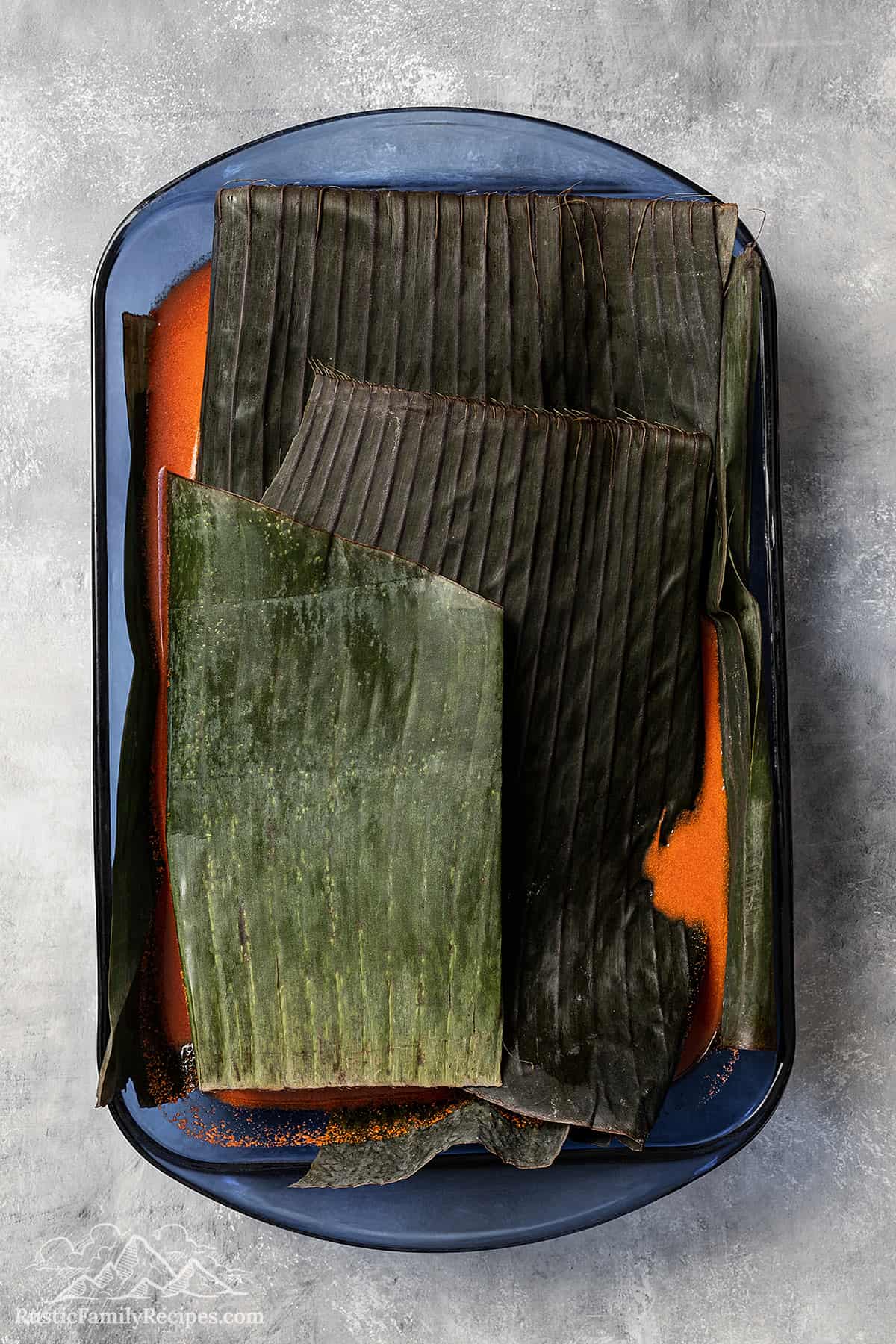 Pork covered with banana leaves.