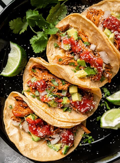 Yucatan pork tacos with toppings.