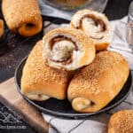 A plate with Senorita bread rolls, one broken in half