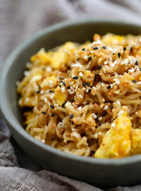 A serving of tik tok ramen with scrambled eggs in a grey bowl