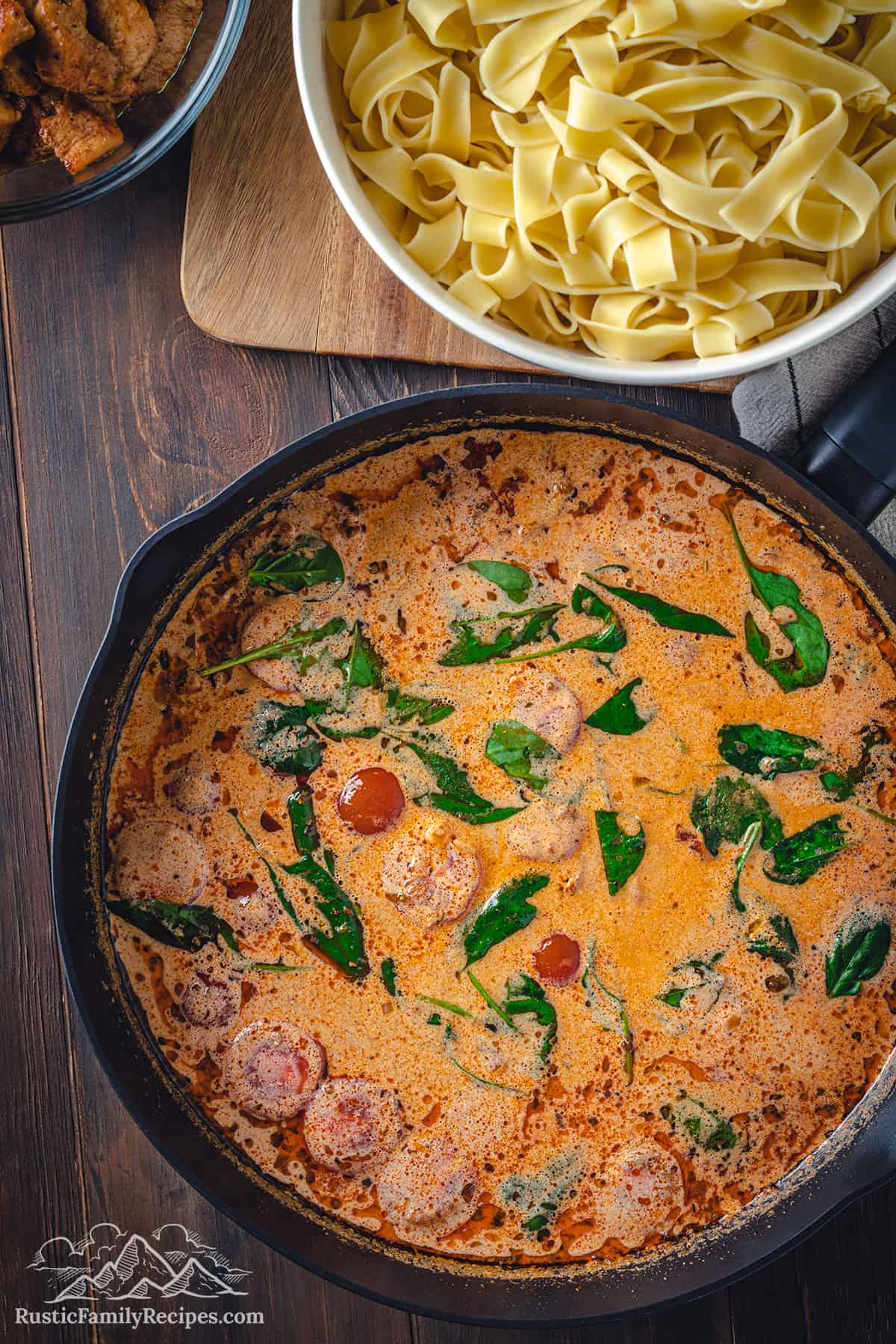 Skillet with sauce for tuscan chicken pasta