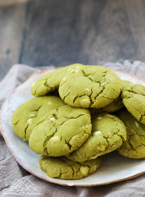 A plate with green matcha white chocolate chip cookies