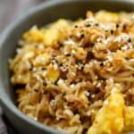 A serving of tik tok ramen with scrambled eggs in a grey bowl