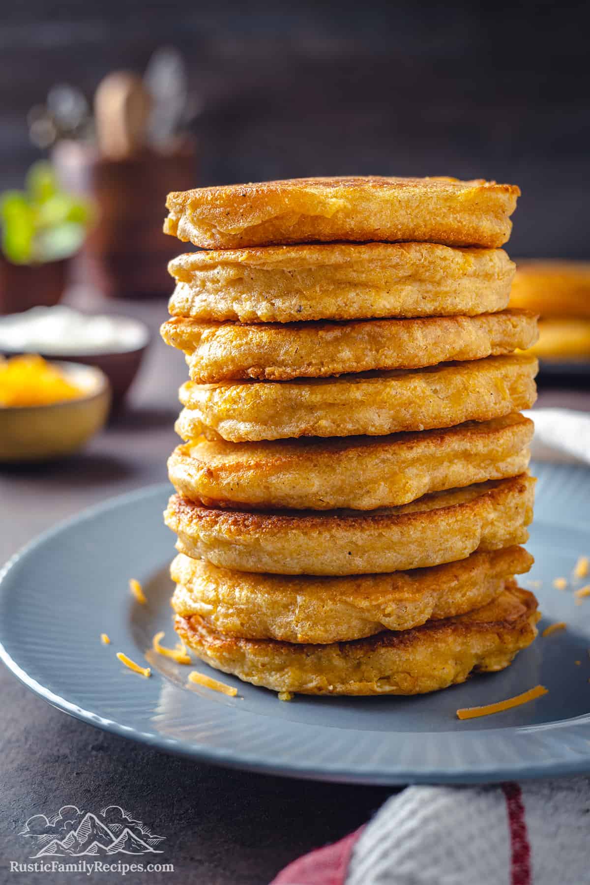 A stack of six golden hot cakes on a blue plate