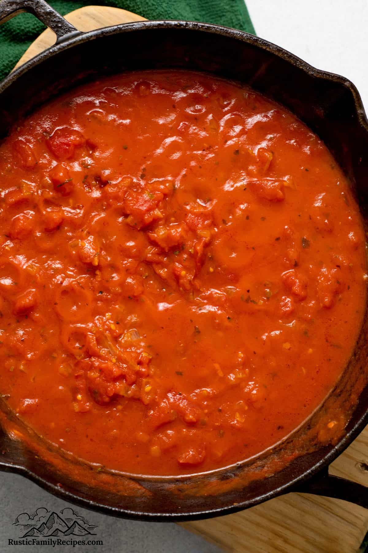 Cooking tomato sauce for Chicken Sorrentino.