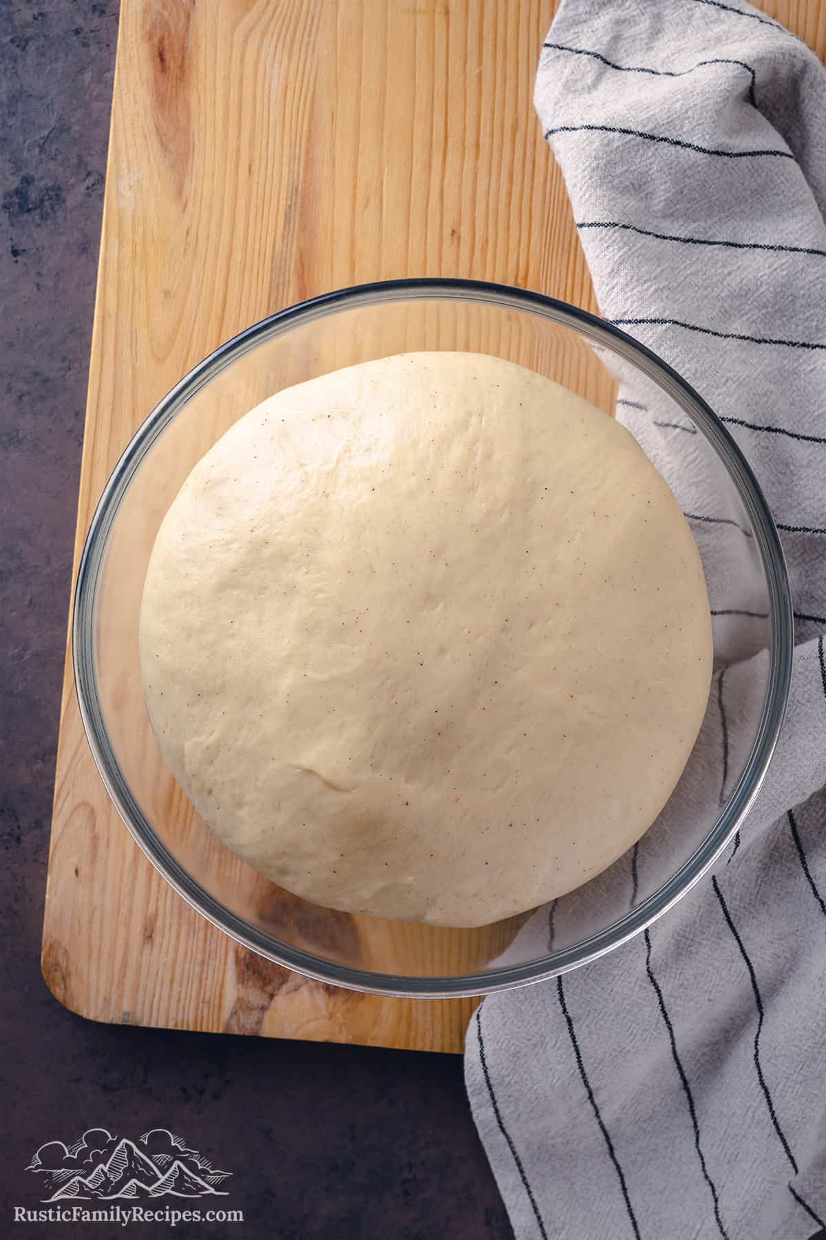 Risen concha dough in a glass bowl
