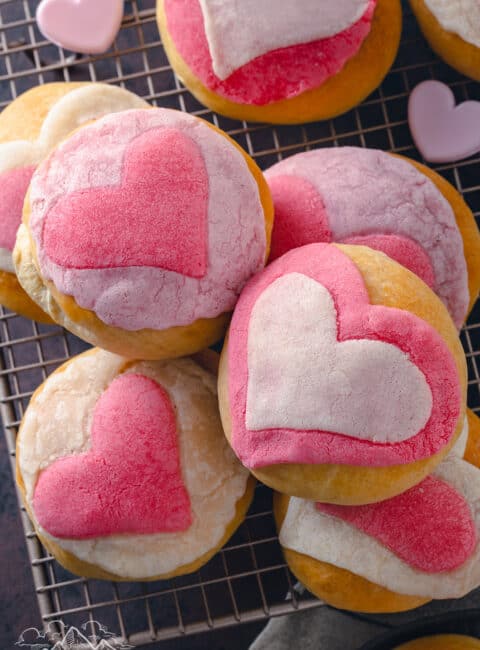 A stack of pink conchas with hearts